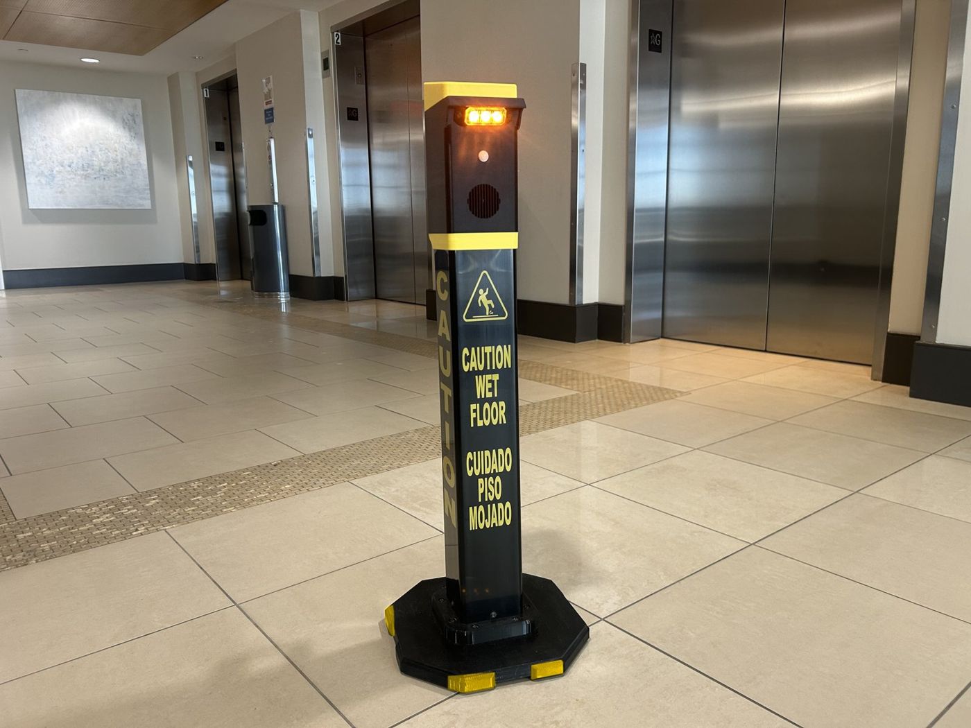 Safety Illuminator Grab n Go Model standing by the elevators, yellow light on